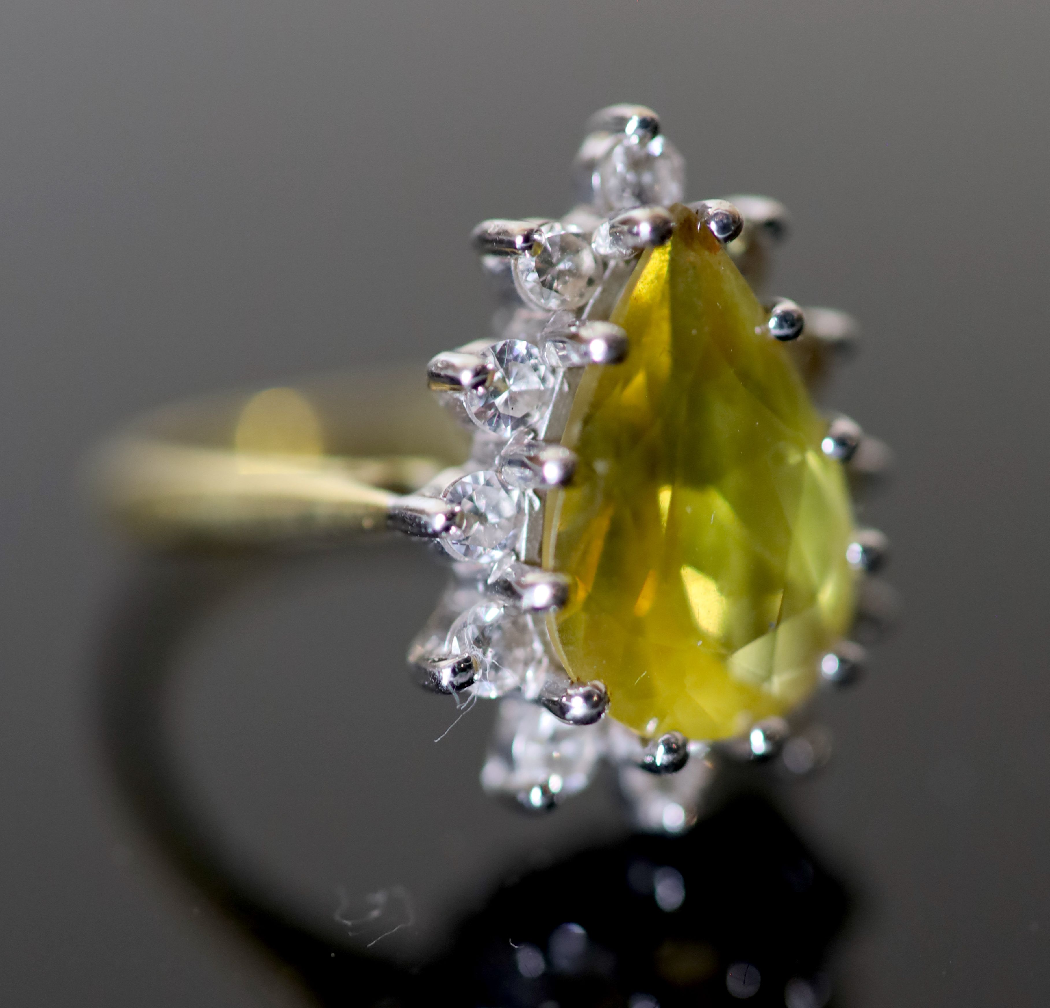A modern 18ct gold, pear shaped yellow tourmaline and diamond set cluster dress ring,